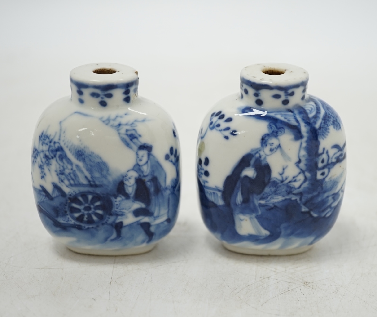 Two Chinese blue and white snuff bottles decorated with figures, largest 6cm high. Condition - fair